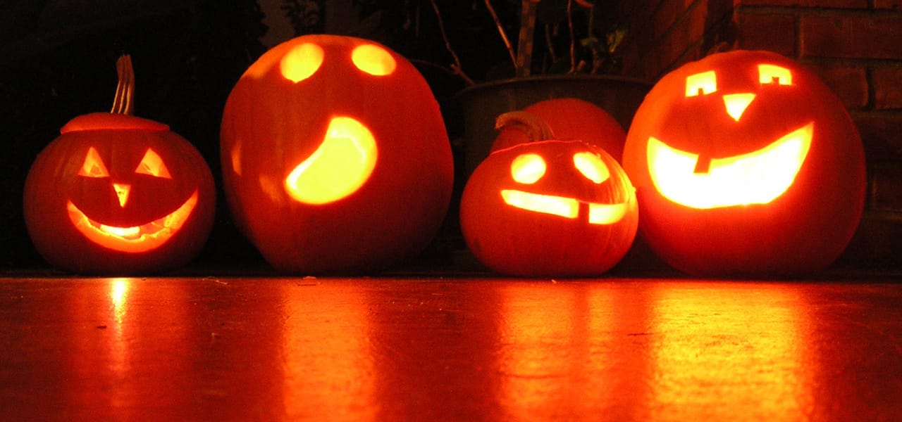 carved pumpkins lit up in the dark