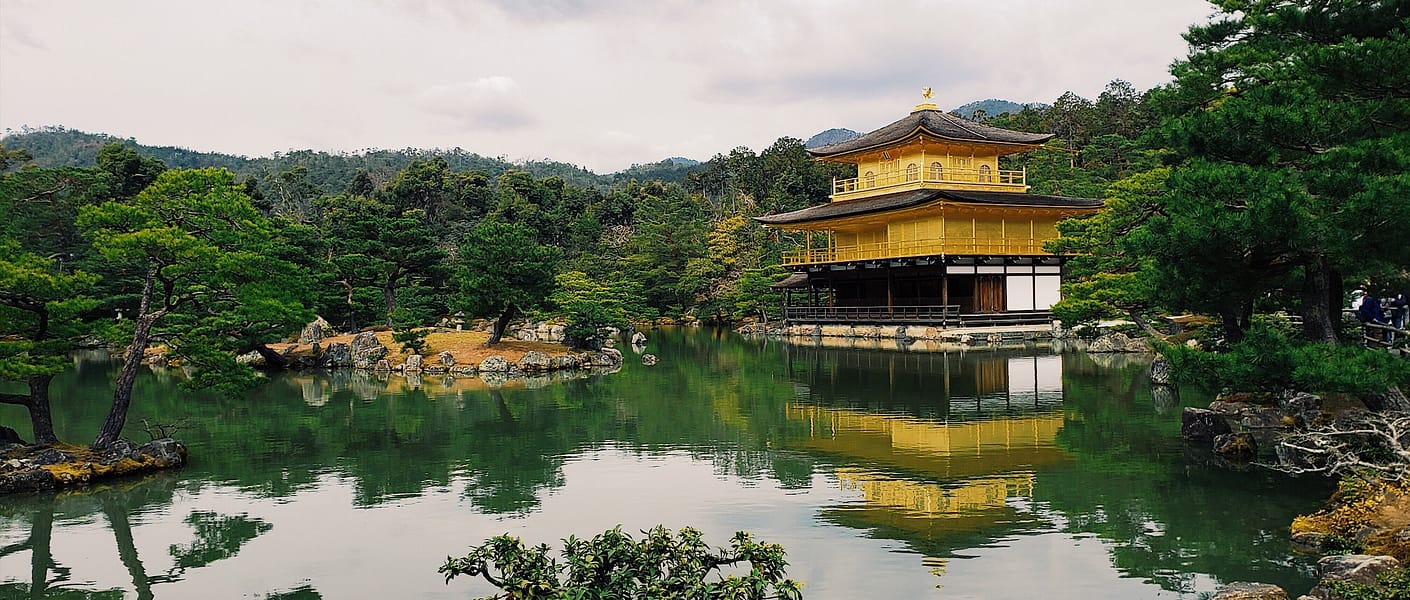 golden pavilion overlooking pond and zen gardens