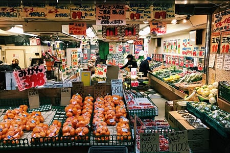 open market stall with veggies and fruits wrapped in plastic