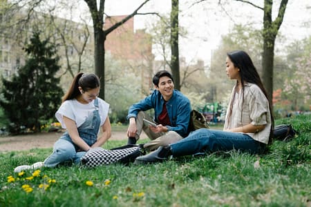 photo of a group of friends sitting on the grass