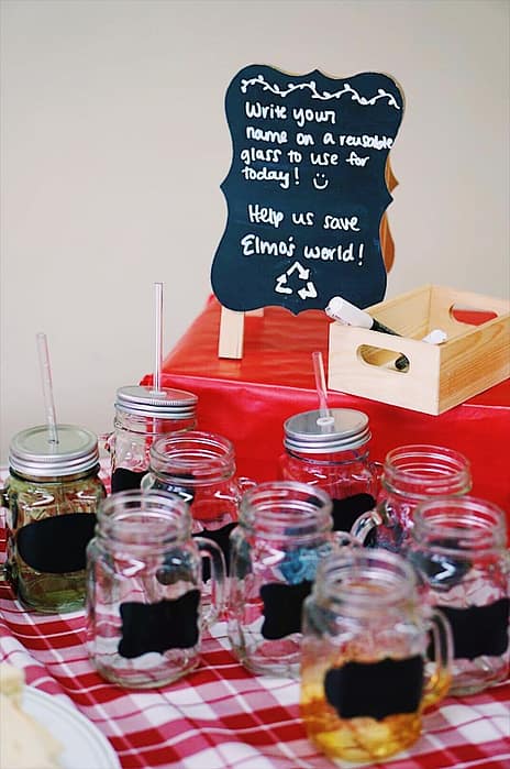 mason jars with chalkboard stickers sitting on a red and white checkered tablecloth