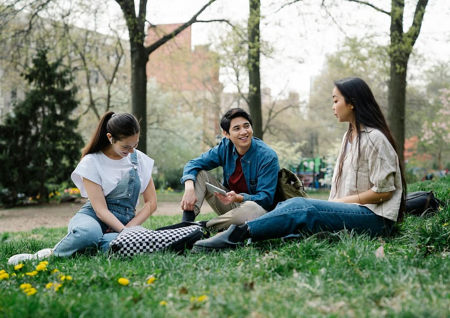 photo of a group of friends sitting on the grass